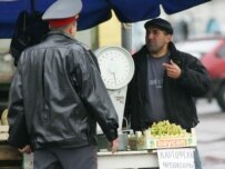 Police checking the documents of a market worker in Ivanovo in October (ITAR-TASS)