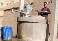 An Afghan boy gets water from a communal well in the village of Wardag (epa)