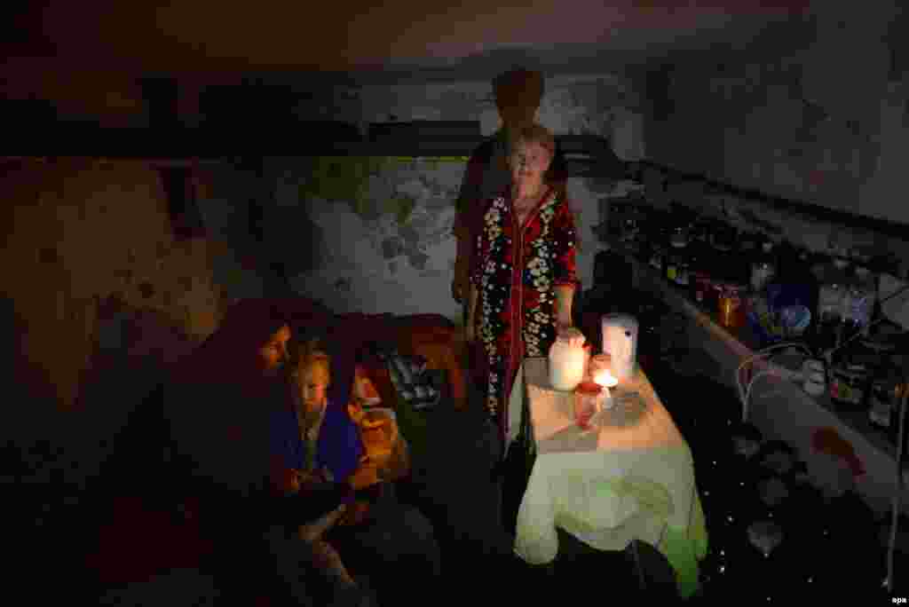 A familly hides in the basement of their house as they turned it into a shelter from shelling in the eastern Ukrainian town of Slovyansk on June 25. (epa)