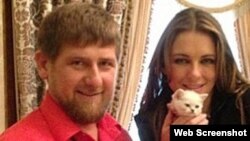 Chechen leader Ramzan Kadyrov (left) with actress Elizabeth Hurley and a white kitten in 2013.