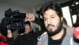 Reza Zarrab, a dual citizen of Turkey and his native Iran, is surrounded by journalists as he arrives at a police center in Istanbul in December  2013. Will his U.S. trial expose facts Turkey's president would rather not be made public?
