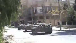 A grab taken from a DPN video shows tanks on the street in Deir el-Zour. 