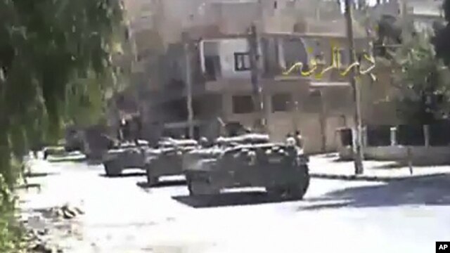 A grab taken from a DPN video shows tanks on the street in Deir el-Zour. 