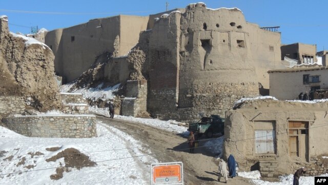 People walk past a section of the old city in Ghazni, which means "jewel."