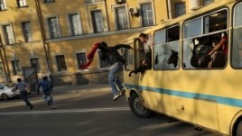 Antigay protesters destroy a bus carrying gay activists during the "Rainbow flashmob" organized in St. Petersburg on May 17.