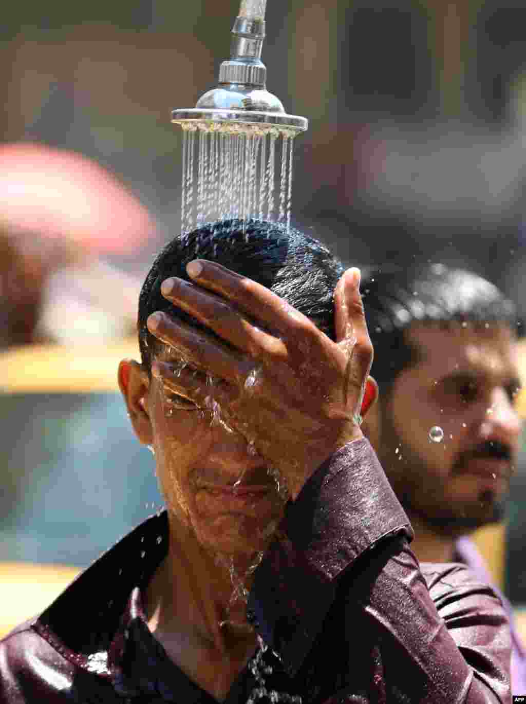 An Iraqi man tries to cool off as temperatures reached 48 degrees Celsius in Baghdad on July 26. (AFP/Ahmad al-Rubaye)