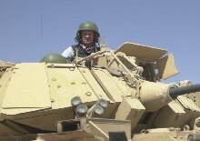 Iraq - RFE/RL correspondent Ron Synovitz rides in a Bradley armored personnel carrier while embedded with the U.S. Army's Third Infantry Division at the start of the Iraq war in March, 2003.