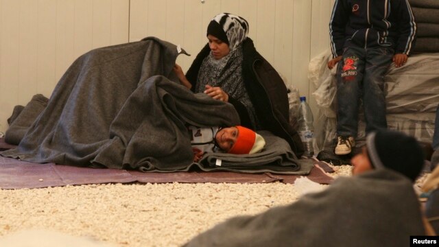 Syrian refugees wait to register their names after their arrival at the Al-Zaatri refugee camp in the Jordanian city of Mafraq, near the border with Syria.