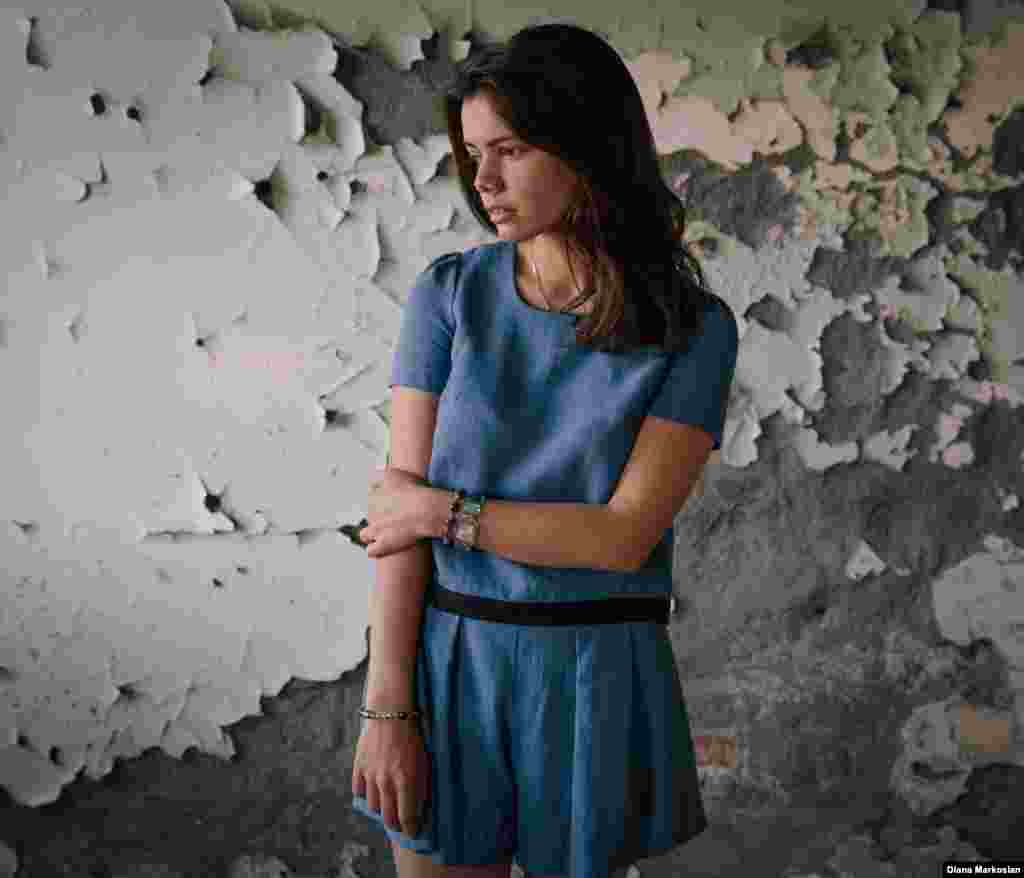 Amina Kachmazova stands in the cafeteria of School No. 1. She was just shy of her 8th birthday when she went to school on September 1, 2004. She walked there with two teenage neighbors, Lyalya and Alina. When the hostages were forced into the gymnasium, she had no relatives with her. She remembers the militants executing a man at the front of the hall to warn everyone to be quiet. Before those days, Amina had never heard of an "explosion." But by the end, she had lost an eye in the blasts that rocked through the room on the third day. Lyalya and Alina were killed. Ten years later, Amina is studying international relations at a university in Vladikavkaz. She laughs easily; she says she loves life. 
