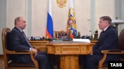 Russian President Vladimir Putin (left) and Russia's Supreme Court Chairman Vyacheslav Lebedev at a meeting the Kremlin says took place on March 13.