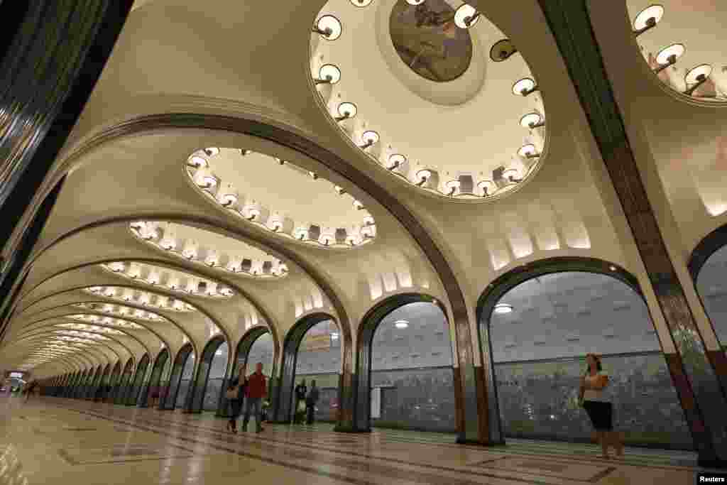 People wait for the train at the Mayakovskaya metro station, built in 1938.