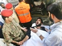 Pakistani security personnel help a man who was injured in the July 10 violence (AFP)