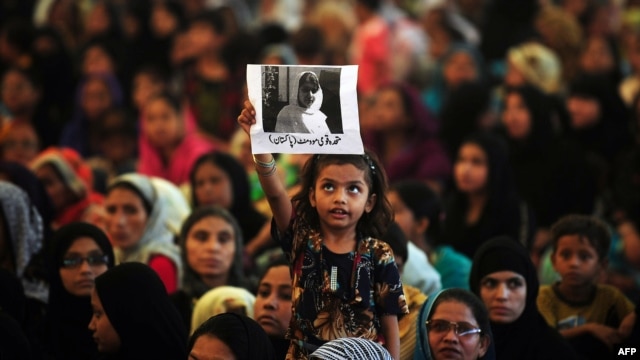 A girl holds a photograph of Malala Yousafzai aloft during a rally in Karachi on October 10.