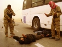 Iraqi security forces detain an alleged militant in Al-Najaf on January 28