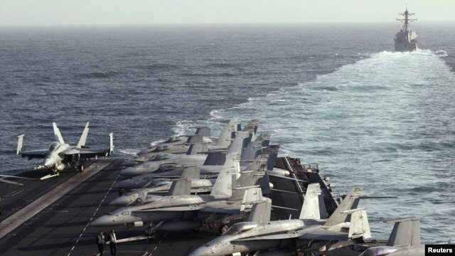 The U.S. destroyer "Sterett" escorts the Nimitz-class aircraft carrier "USS Abraham Lincoln" during a transit through the Strait of Hormuz in February.