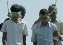 Mahmud Asgari, 16, (right) and Ayaz Marhoni, 18, were convicted of raping a young boy and executed in July 2005 (AFP)