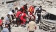 Syrian rescue workers carry a victim on a stretcher following a reported air strike on the rebel-held northwestern city of Idlib on August 17.