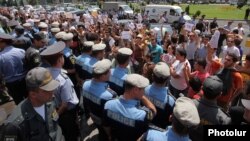 Armenian youth activists demonstrate against bus fare hikes outside municipal offices in Yerevan earlier this week.