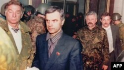 Former Supreme Soviet Chairman Ruslan Khasbulatov (second from left) and former Vice President Aleksandr Rutskoi (third from left) are arrested in Moscow on October 4, 1993.