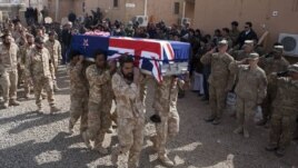 Soldiers carry the coffins of two New Zealand soldiers killed in Banyan Province in a battle with Taliban insurgents.