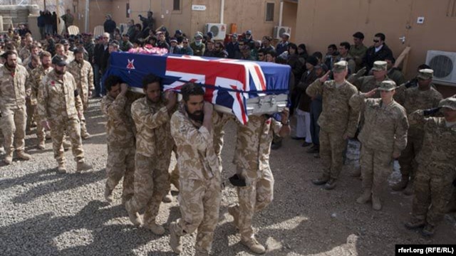 Soldiers carry the coffins of two New Zealand soldiers killed in Banyan Province in a battle with Taliban insurgents.