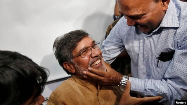 Kailash Satyarthi (center) is congratulated on winning the Nobel Peace Prize at his office in New Delhi.