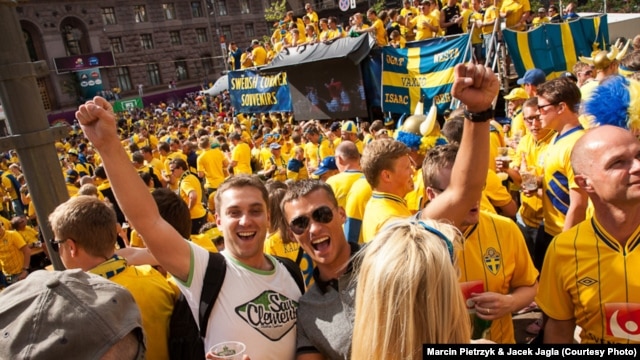 Polish fans Jacek (left) and Piotrek amid a sea of Swedish supporters during the Euro 2012 soccer championships in Kyiv on June 15.