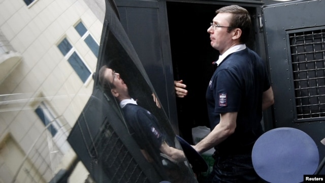 Former Ukrainian Interior Minister Yuriy Lutsenko gets into a police truck after a court session in Kyiv in August 2012.