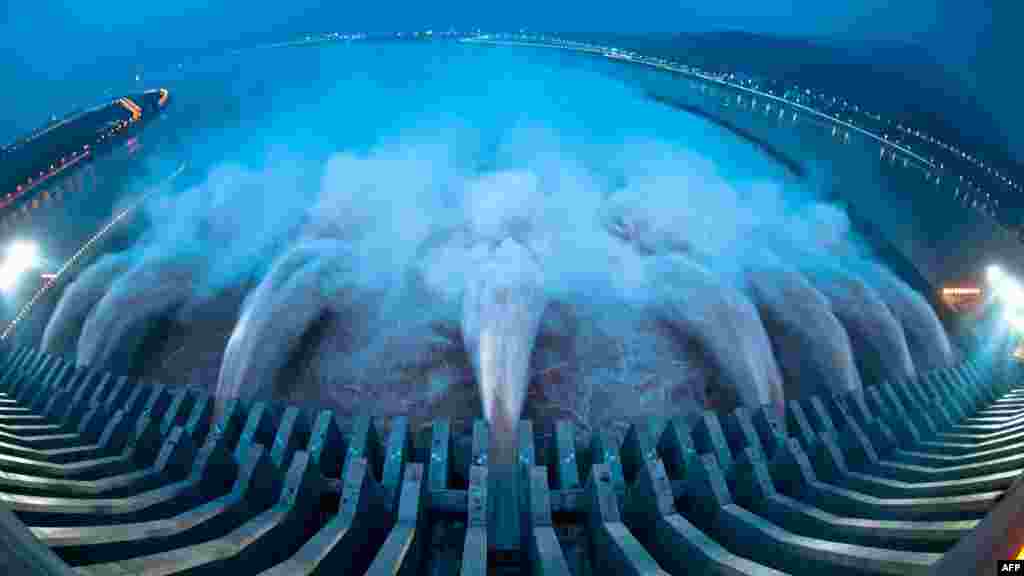 Water is released from the Three Gorges Dam, the gigantic hydropower project on the Yangtze River in central China's Hubei Province on July 24 after heavy downpours in the upper reaches of the dam caused the highest flood peak of the year. (AFP)
