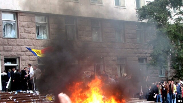 Moldova -- Protesters shout anti-communist slogans as a fire burns outside the parliament building in Chisinau, 07Apr2009