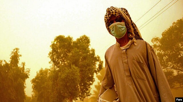 A resident covered up against a dust storm blowing through Khuzestan Province (file photo)