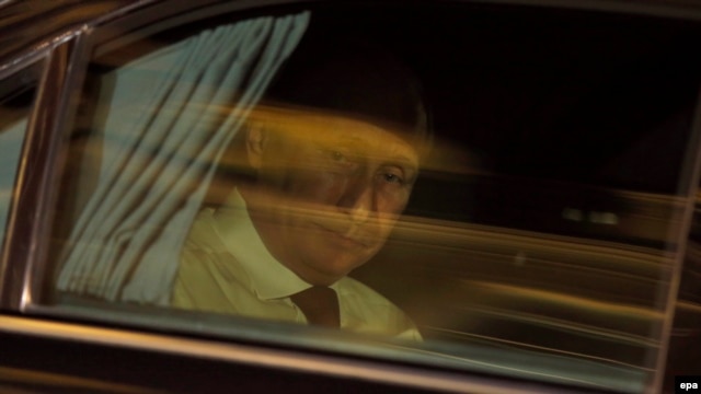 Vladimir Putin leaves the Elysee Palace after a meeting with Francois Hollande