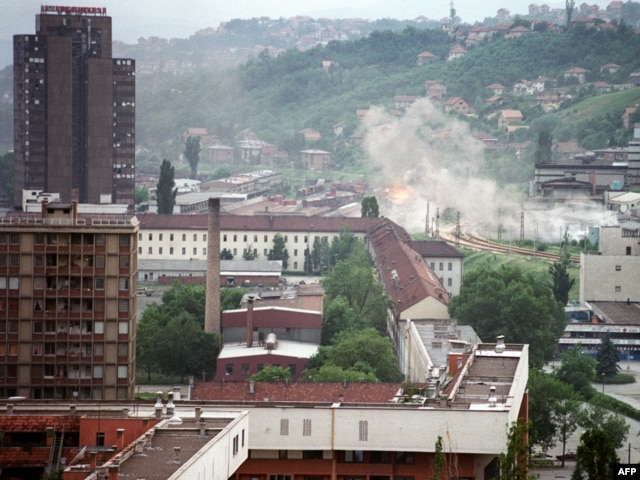Shells hit houses in the suburbs of Sarajevo in August 1992.