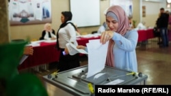 A woman in the Chechen capital, Grozny, cast her vote in Russia's State Duma elections on September 18.