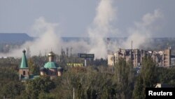 Smoke rises near Donetsk's Sergei Prokofiyev International Airport , which has been the scene of heavy fighting in recent days.