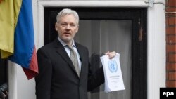 Julian Assange speaks to the media from a balcony of the Ecuadorian Embassy in London in February.