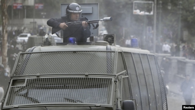 Egyptian riot police used tear gas in battles with protesters January 28 in Cairo.
