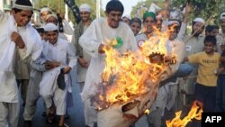 Pakistani protesters burn an effigy of Obama in Lahore in May 2010.