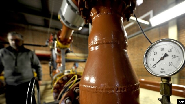 A technician from state-owned Sarajevo Gas shows zero pressure on a gauge at a gas distribution facility near Sarajevo on January 7.