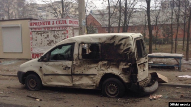 A burned-out car in Mariupol following a January 24 rocket attack on the city that killed dozens of civilians.