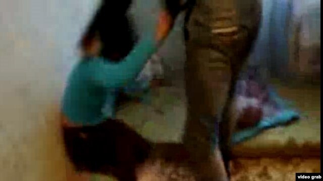 Screengrab from a video showing a Kyrgyz woman, "Ajna," being beaten, purportedly for associating with non-Kyrgyz men