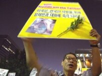 A protester calls for the hostages' safe return and the withdrawal of South Korean troops (AFP)