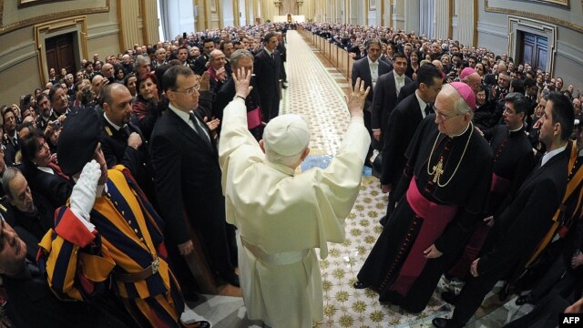 Pope Benedict XVI waves as he arrives at a private audience at the Vatican in 2011.