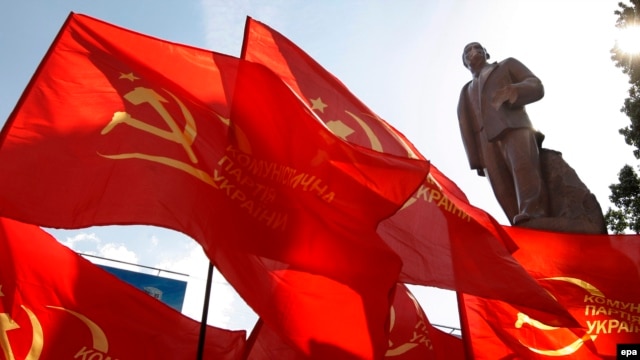 Seeing red: Communist flags fly next to the same statue of Lenin in Kyiv in 2009, three years before the "Euromaidan" unrest swept it off its feet.