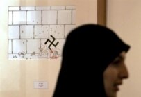A woman at the Holocaust cartoon exhibition in Tehran on August 14 (AFP)