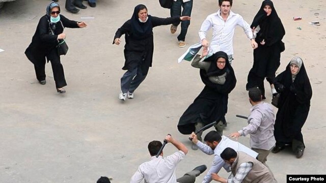 Women come to the aid of a man being beaten during election protests last June.