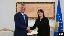 Outgoing Kosovo President Atifete Jahjaga (right) meets with newly elected President Hashim Thaci before he was sworn into office in Pristina on April 7.