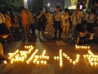 South Koreans light candles during a rally in Seoul to ask for the safe return of the hostages (AFP)