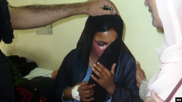 The victim of an acid attack is comforted at a local hospital in Quetta in 2010. Activists say about 150 women are attacked with acid every year in Pakistan.
