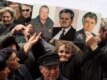 A Kosovar Serb holds pictures of Mladic, Milosevic, and Karadzic during a 2007 protest against independence for Kosovo